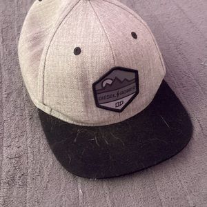 Grey, green and black hat with diesel logo.